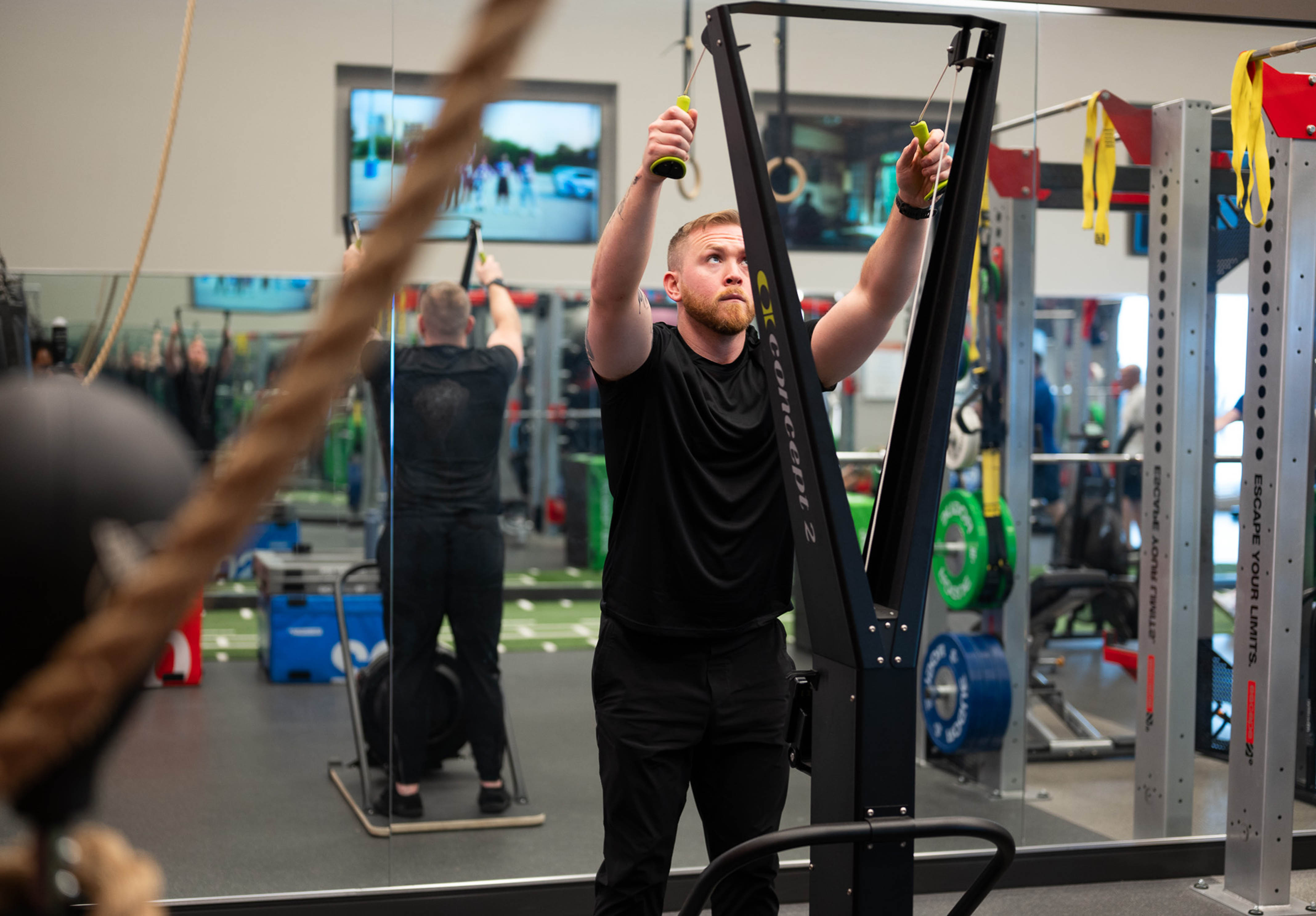 Male in the Strength Lab at the Toronto Athletic Club using the ski erg machine